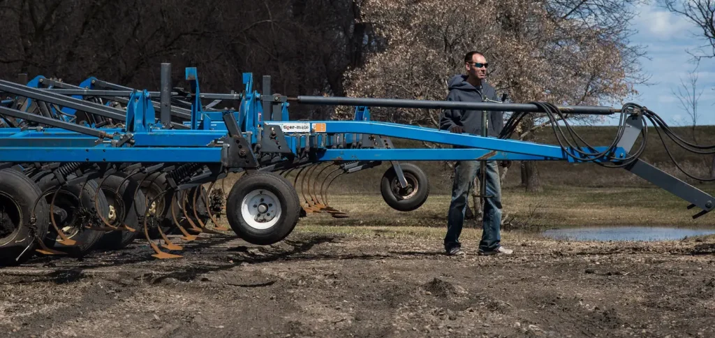 Jeff Hoff builds up and modifies an earthen dike at his farmstead in Perley