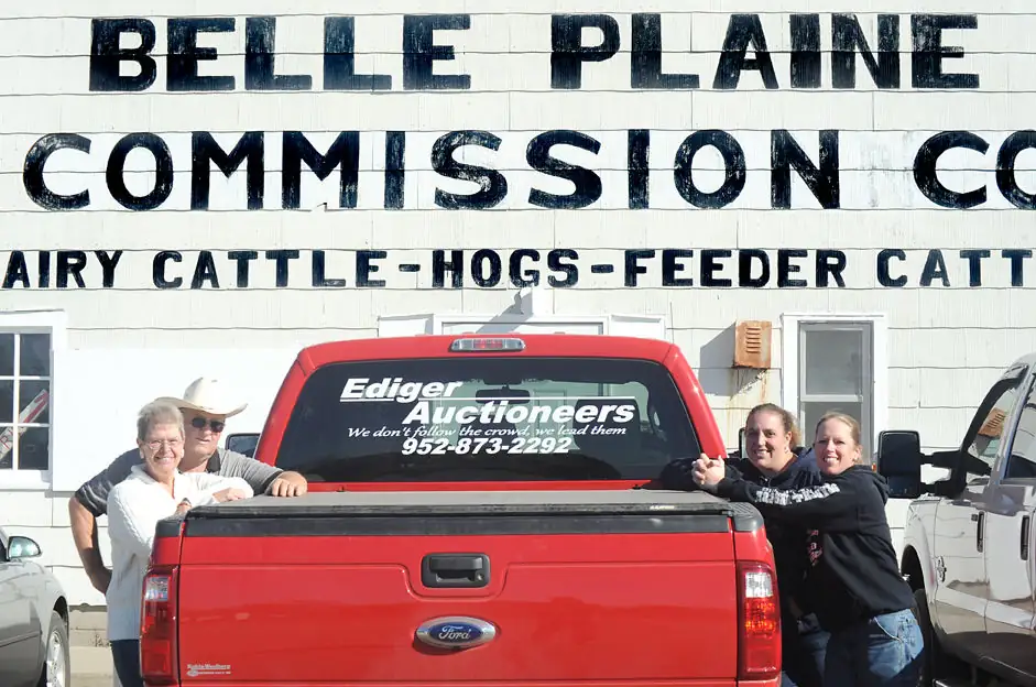 : (The Ediger family in front of the Belle Plaine Commission Company includes Pat and Deb (on left)