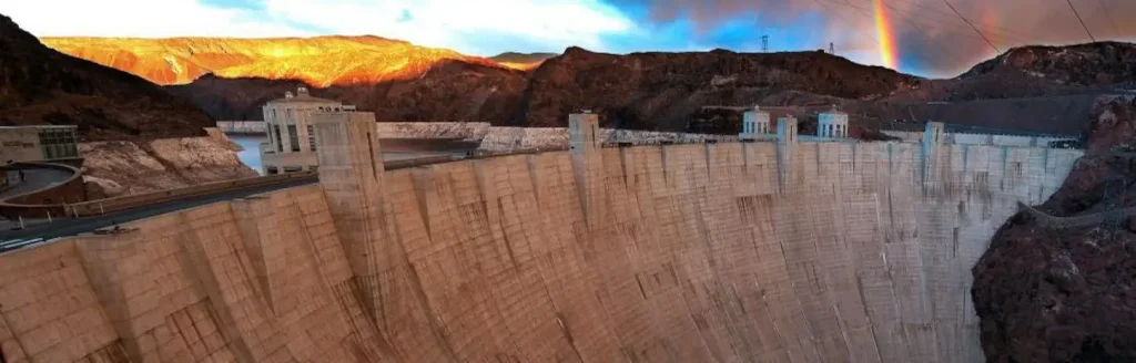 Panoramic view of Hoover Dam and the edge of a rainbow.