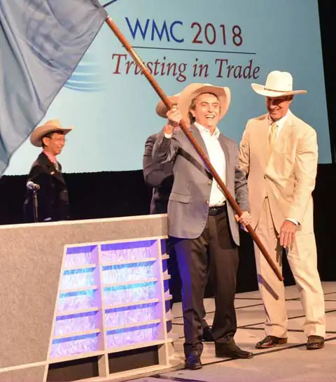 USMEF CEO Emeritus Philip Seng passes the International Meat Secretariat flag to Pedro Tabares of Granjas Carroll de Mexico